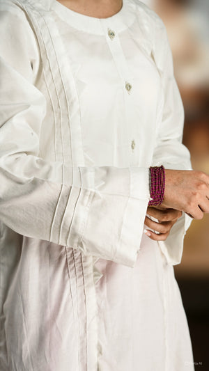Close-up of a person wearing a white outfit with a blurred background